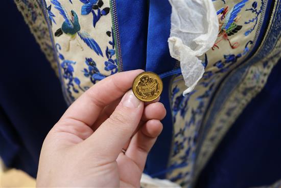 A Chinese silk embroidered robe c.1920s, embroidered with panels of birds and flowers on royal blue silk